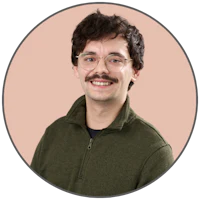 a young man wearing glasses and a hawaiian shirt
